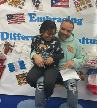 father and kid sitting and smiling