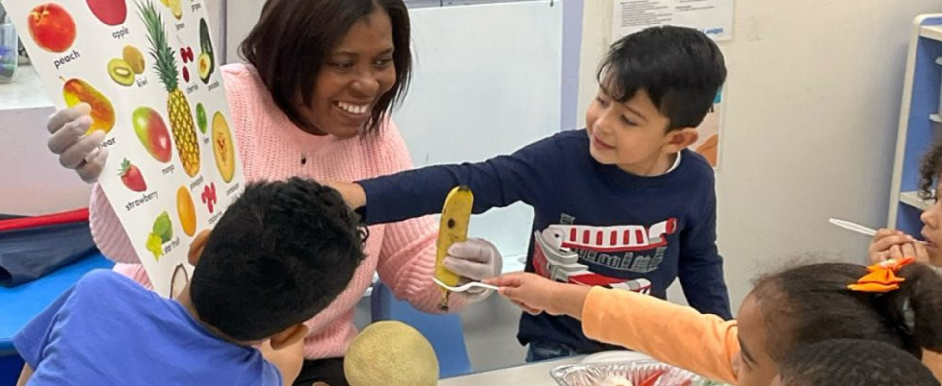 female teacher with four little kids smiling