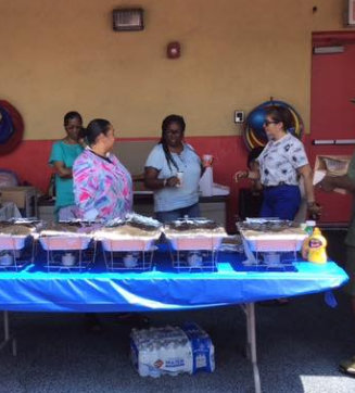 elderly teachers preparing food for children