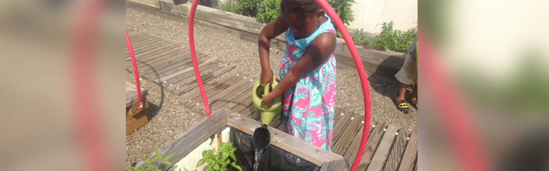 female kid watering plants