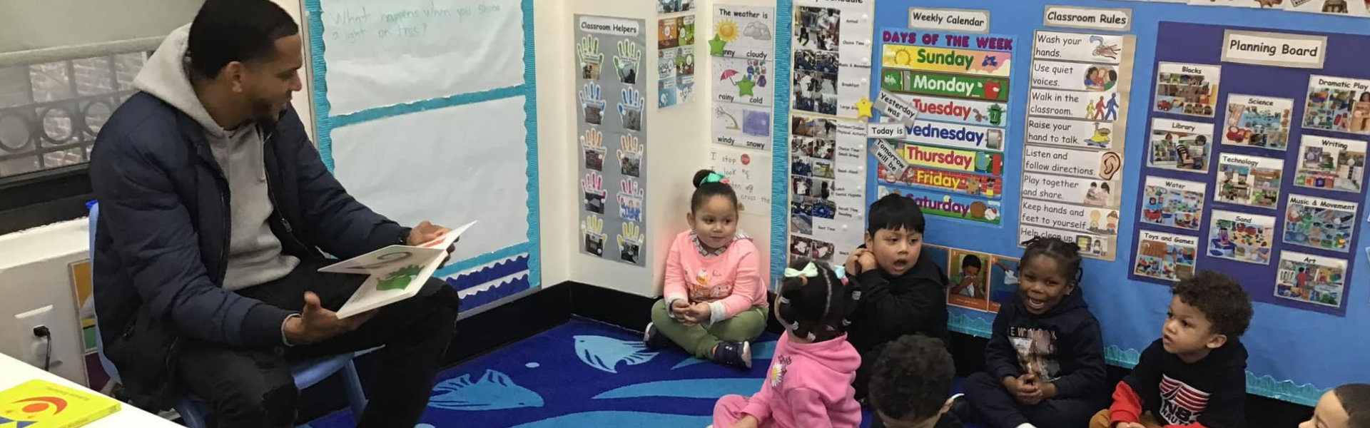 male teacher talking to a group of kids