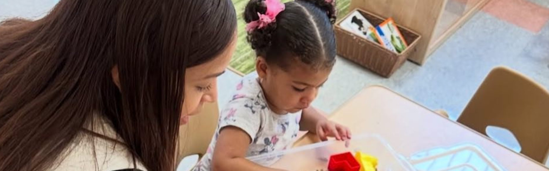 woman teaching a little girl